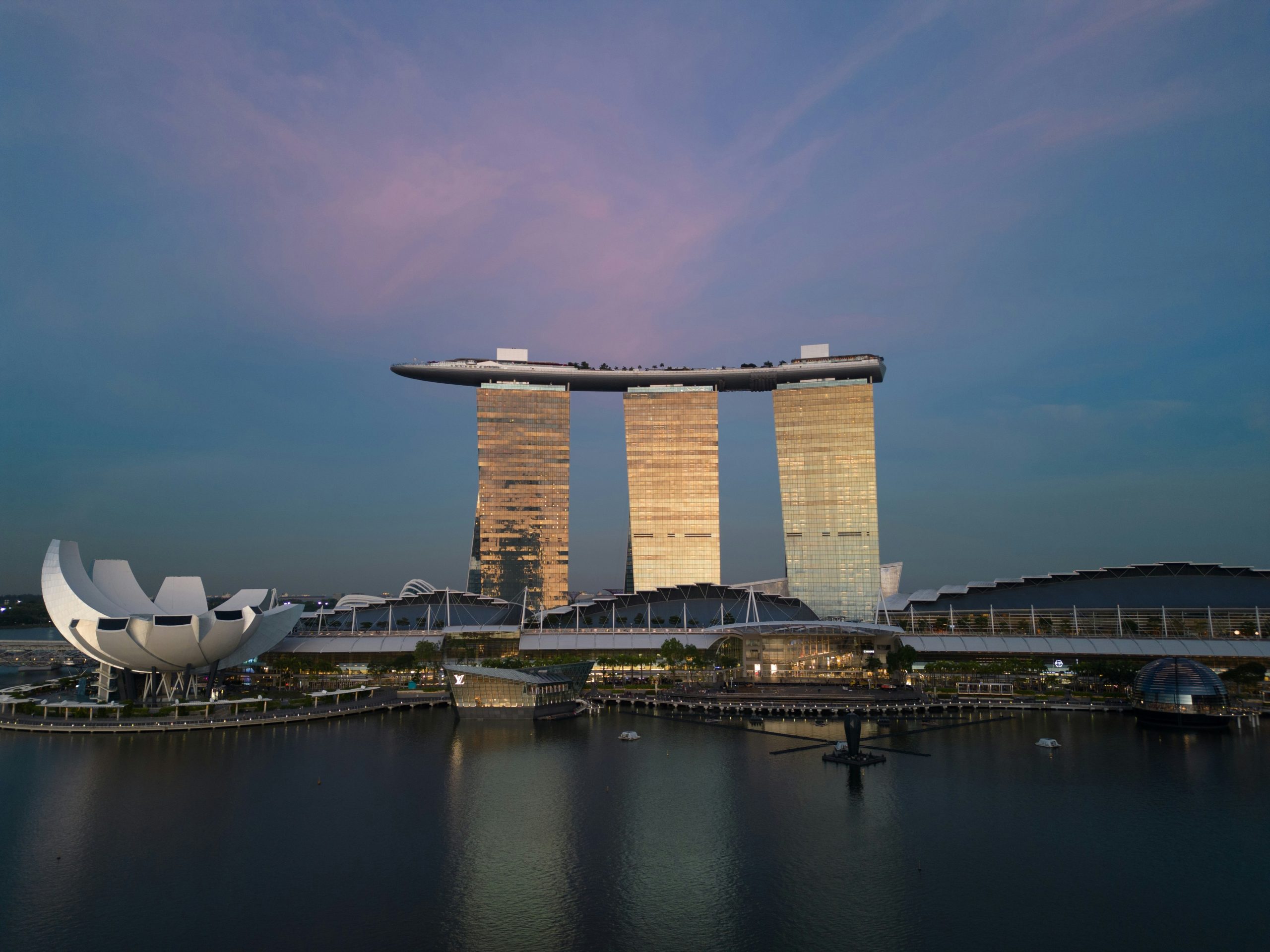 Marina Bay Sands towers rise over Singapore's waterfront at dusk