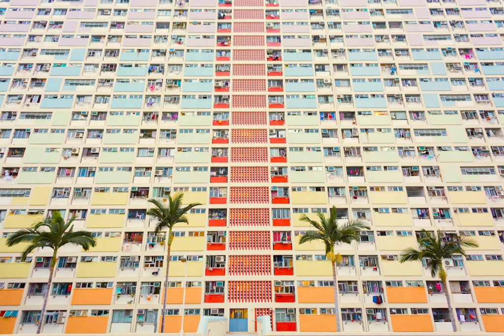 Choi Hung Estate in Hong Kong is famous for its vibrant, colorful facade, featuring a striking array of pastel hues that brighten the residential buildings and create a visually stunning backdrop.