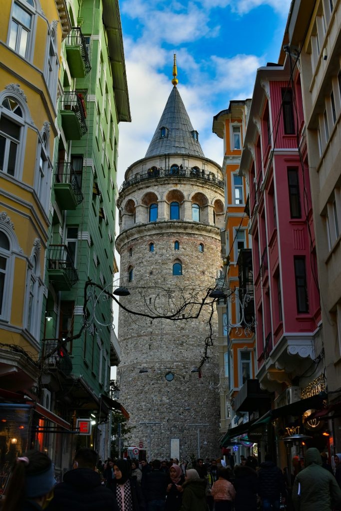 View of the Galata Tower in Istanbul, surrounded by the city’s vibrant buildings.