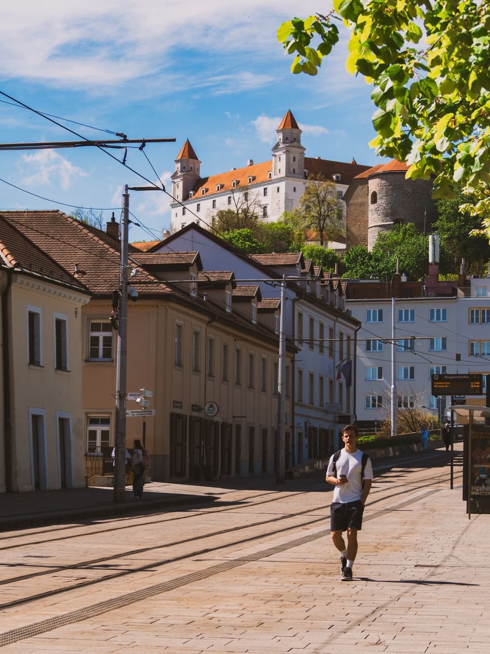 Bratislava Castle above a cobbled street in the Old Town.