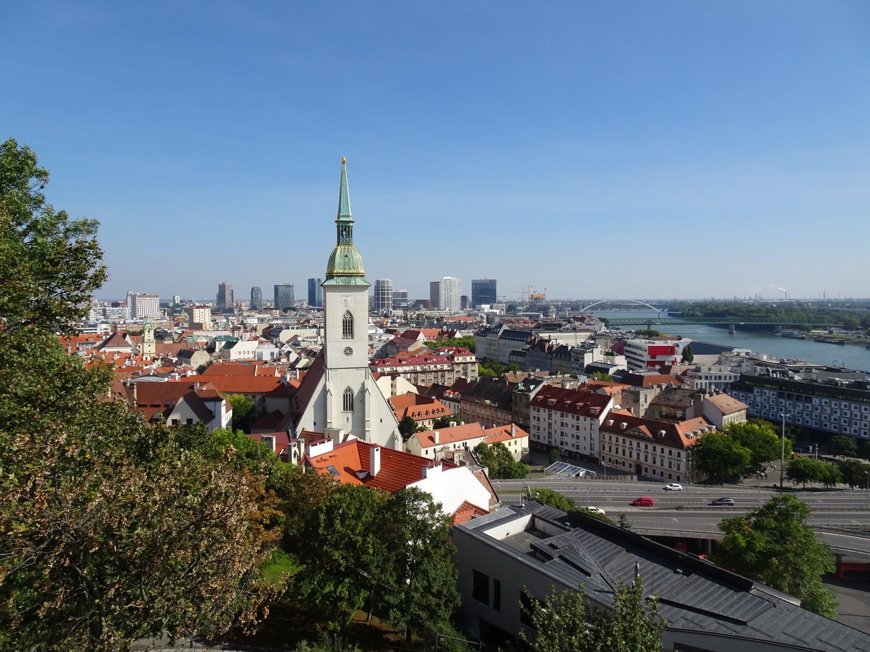 A panoramic view of Bratislava's Old Town, with church towers rising above the rooftops.