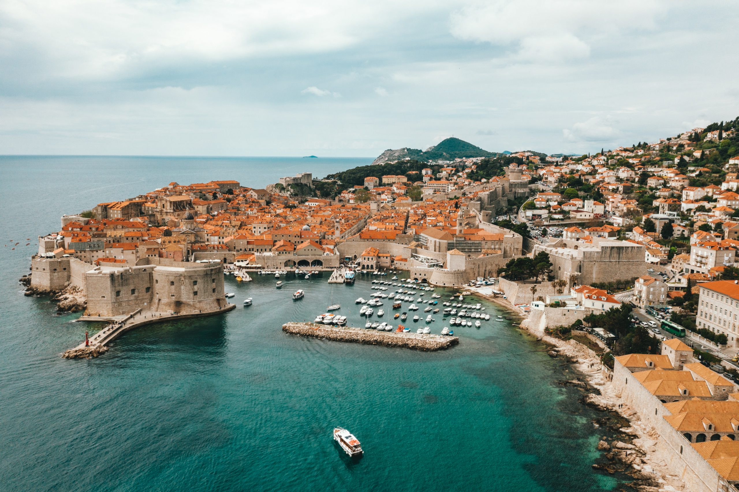 Students look out over Dubrovnik's walled old town and harbor along the Adriatic coast