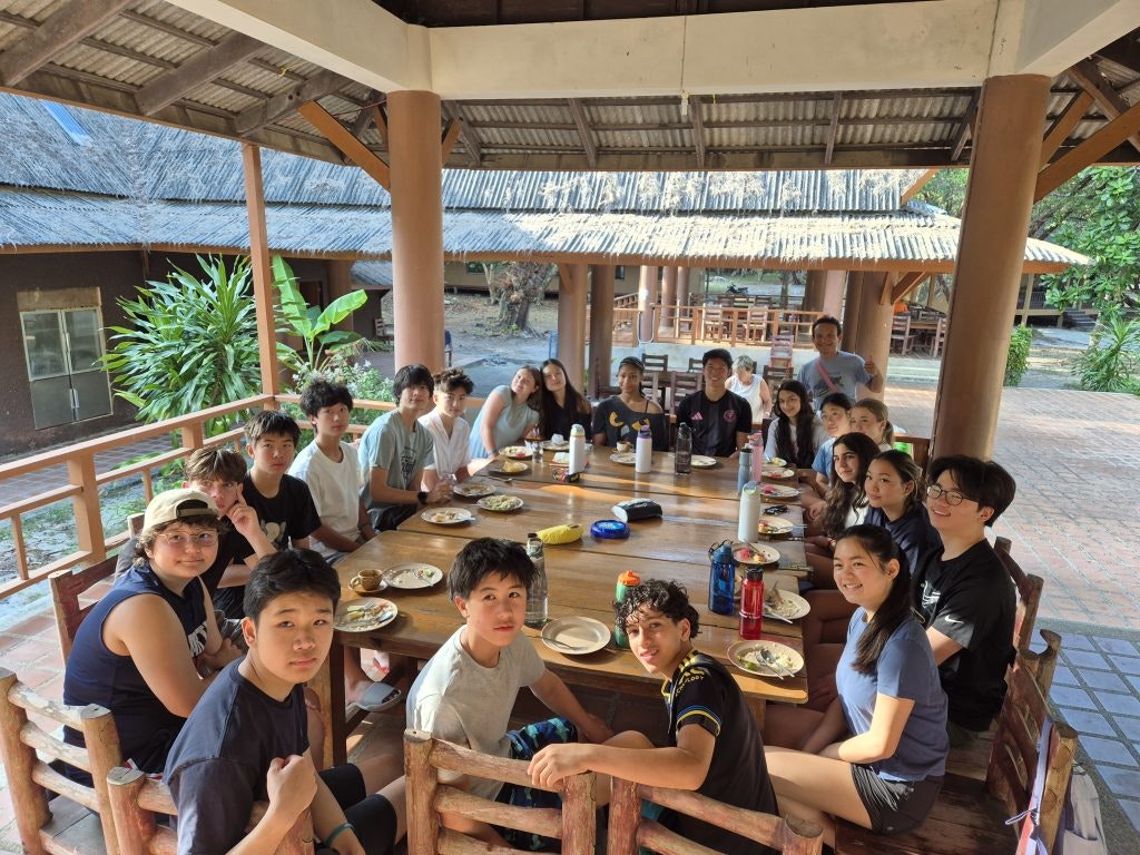 Students sharing a meal together on a school trip, building connection and confidence