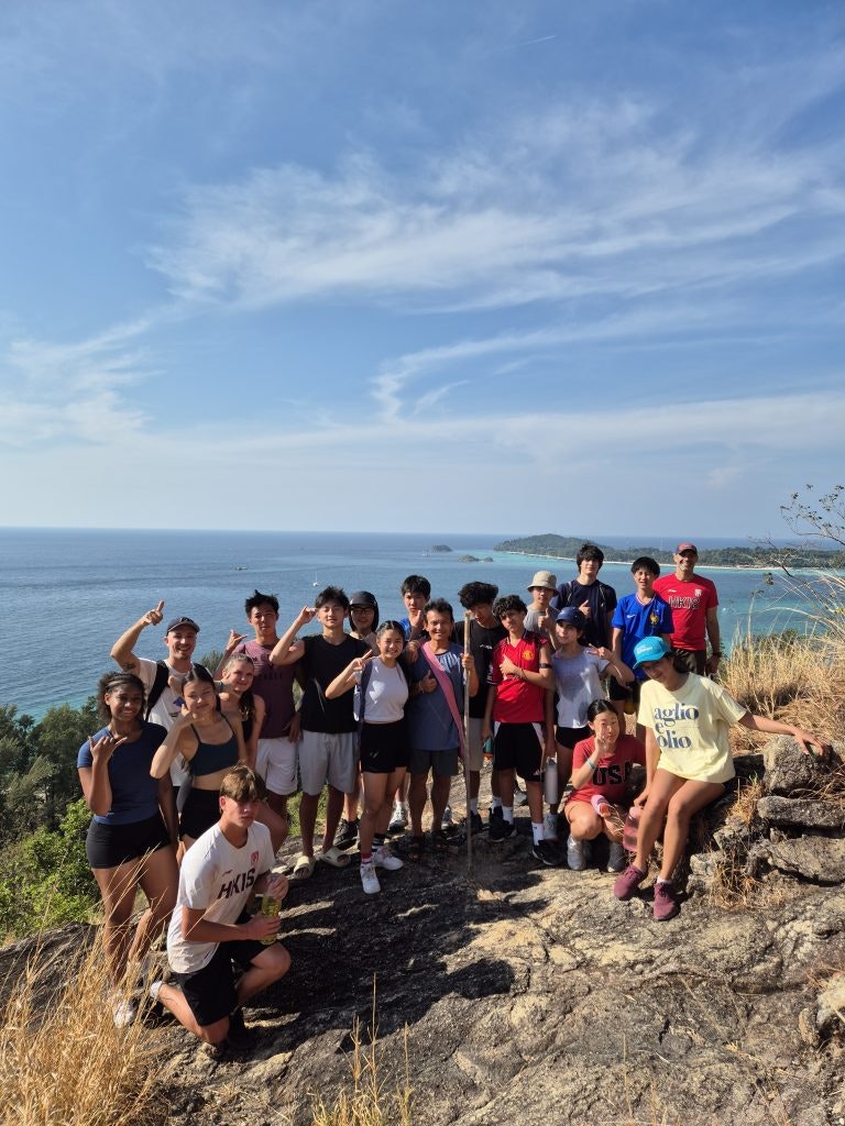 Students at a scenic viewpoint in Thailand during a hike on a group travel trip