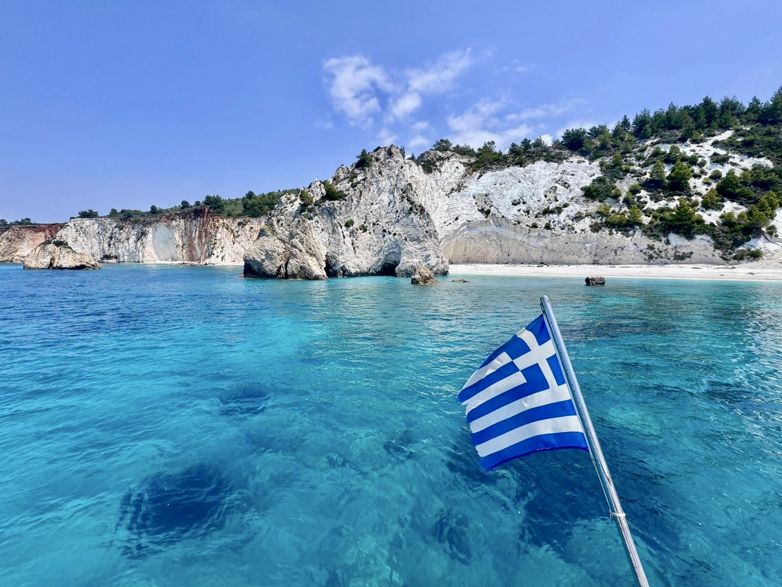 Group of high school summer program students at the I love Kefalonia sign on the Ionian waterfront