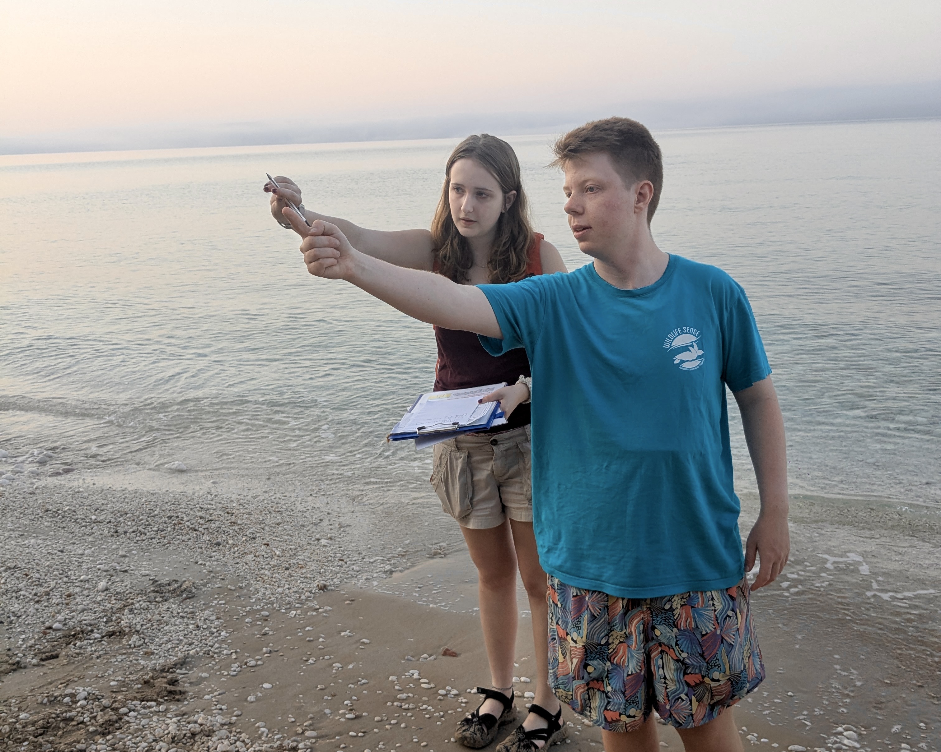 Summer program leader briefing high school students during a loggerhead turtle nesting survey on a Greek beach