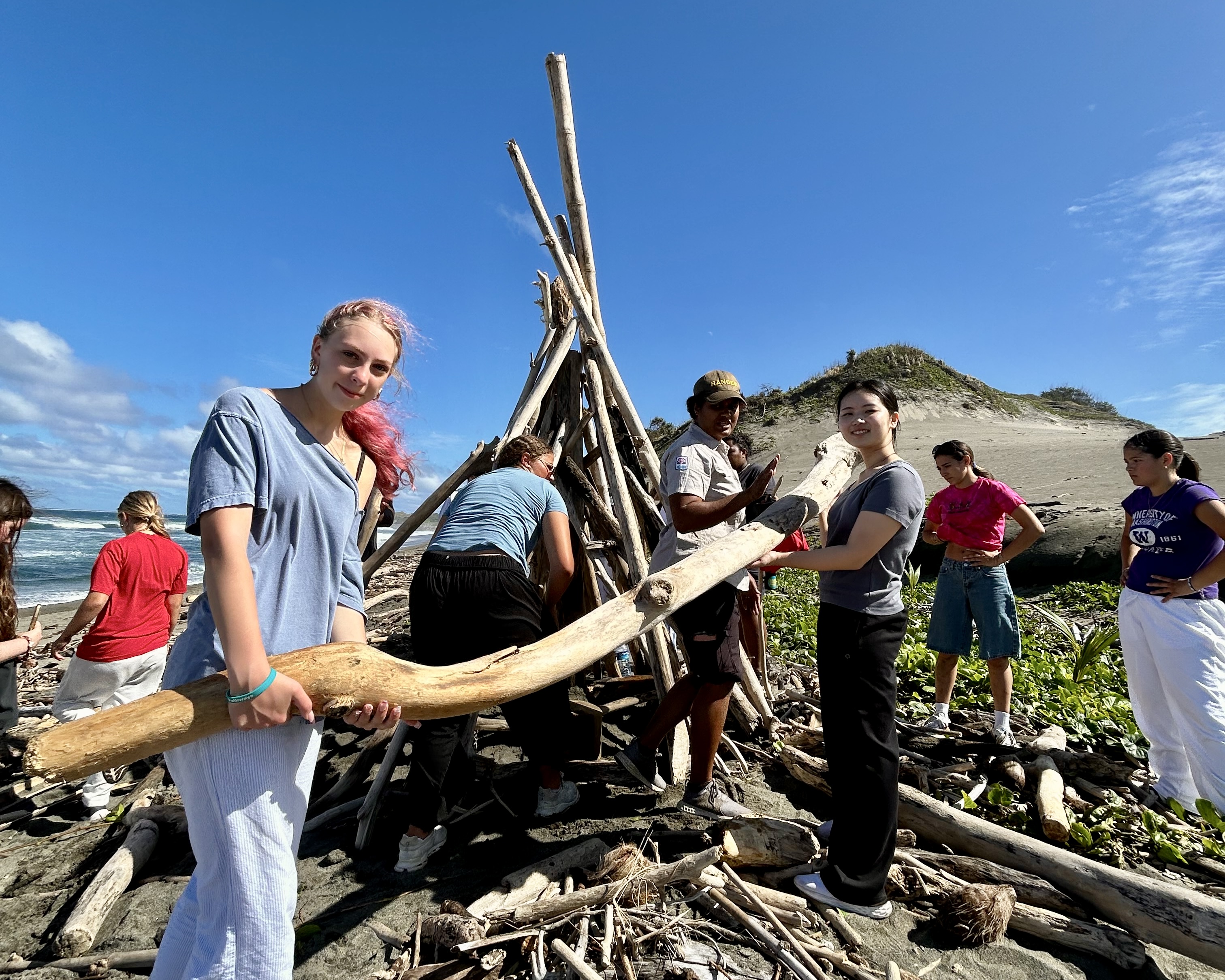 Teen volunteer grouting floor tiles during a community service project in a Fijian village