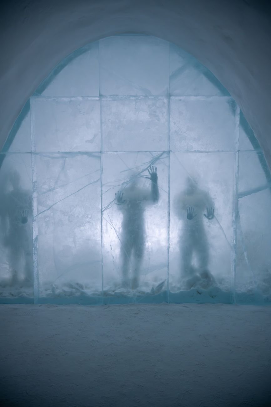 Carved ice walls and furniture inside a room built entirely of ice and snow.