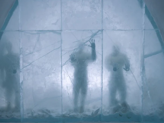 Carved ice walls and furniture inside a room built entirely of ice and snow.