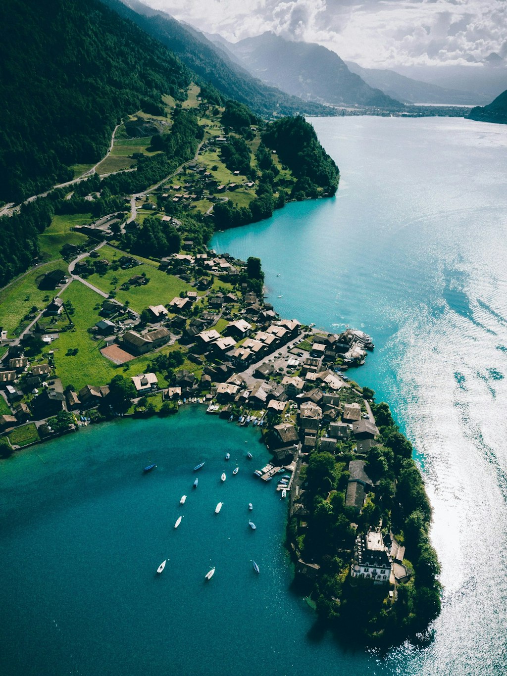 Aerial photo of Grindelwald in Switzerland with view of town and ocean.