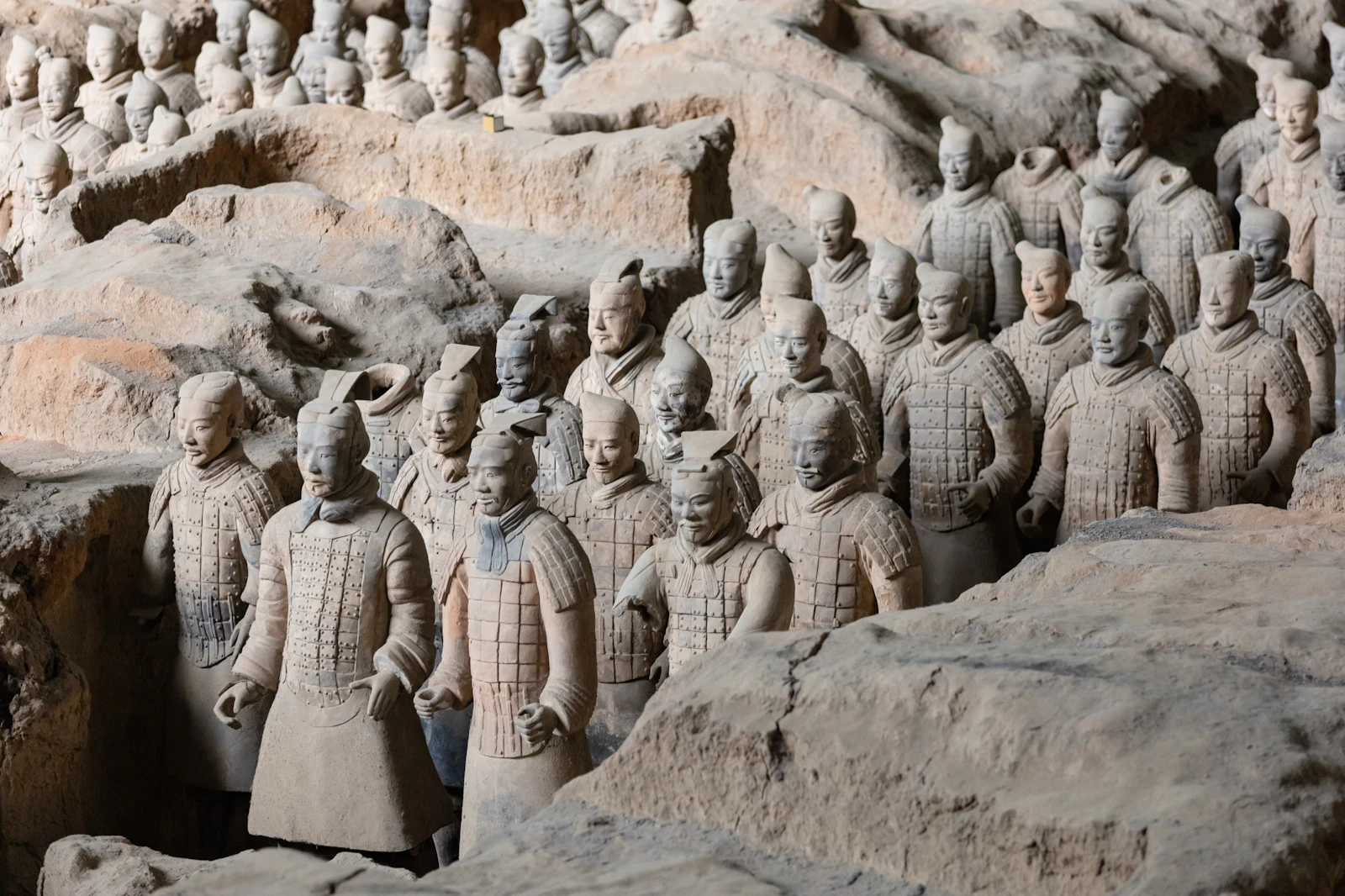 Rows of terracotta warriors stand in an excavated pit in Xi’an, China