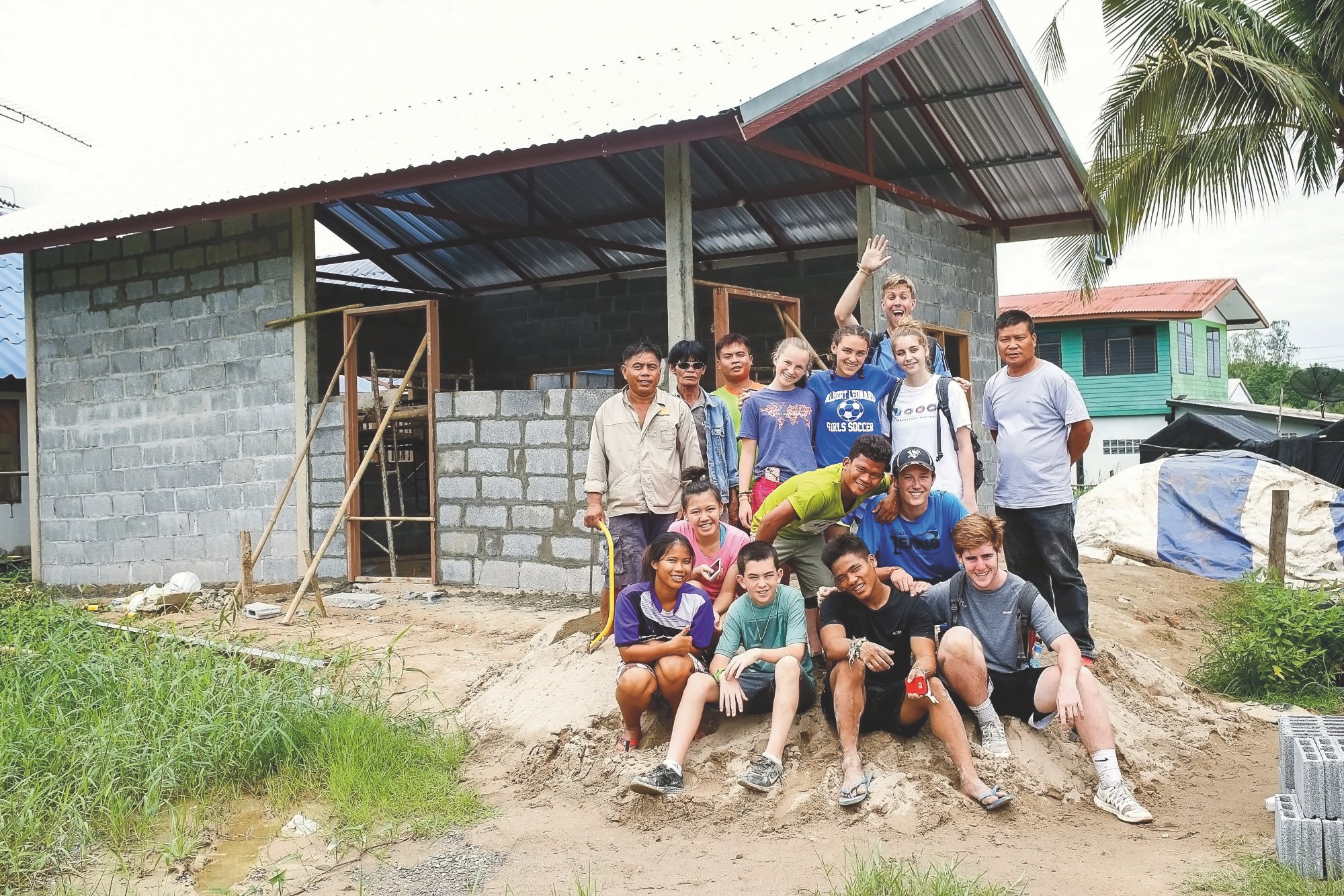 Rustic Pathways students and community members in front of a construction project in Thailand