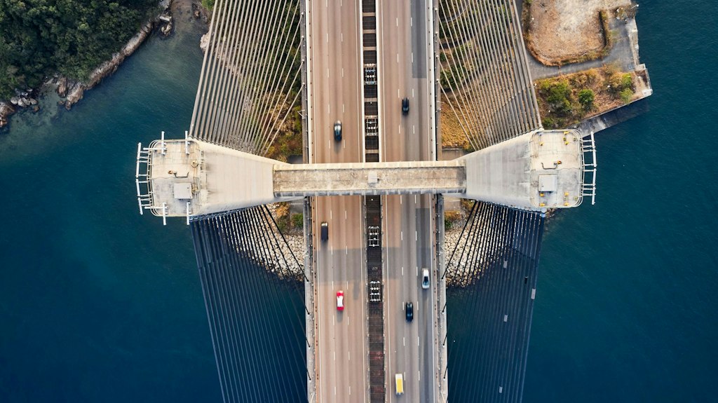 Aerial view of Tsing Ma Bridge showcasing cars crossing the architectural marvel.