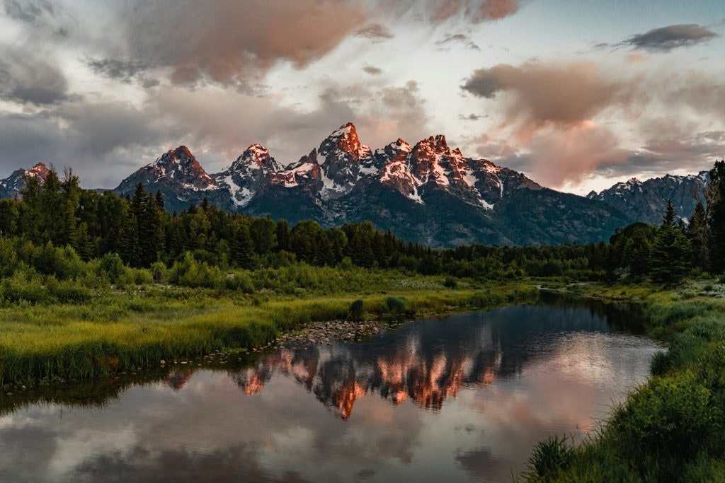 Grand Teton National Park, shows a pond and a large mountain in the background.
