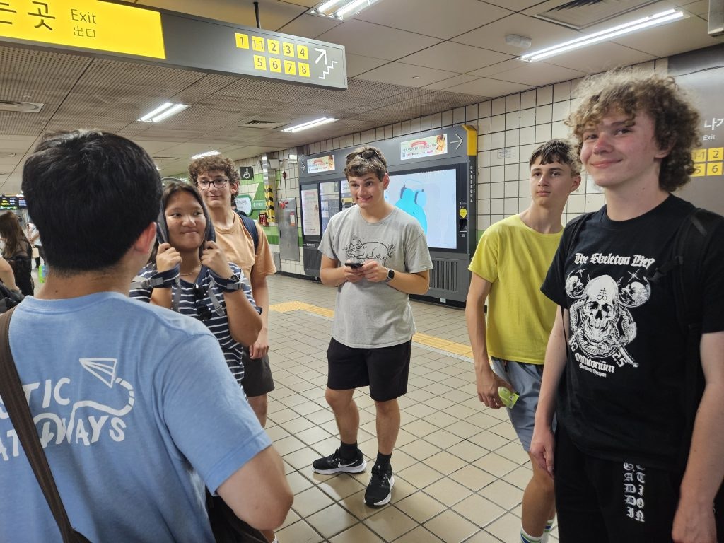 Rustic Pathways Program Leader getting students ready to board the subway
