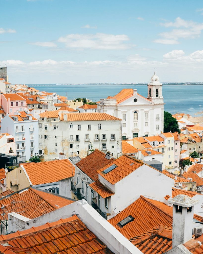 fun facts about portugal. Orange tiles contrasts with the clear blue sky in Lisbon.