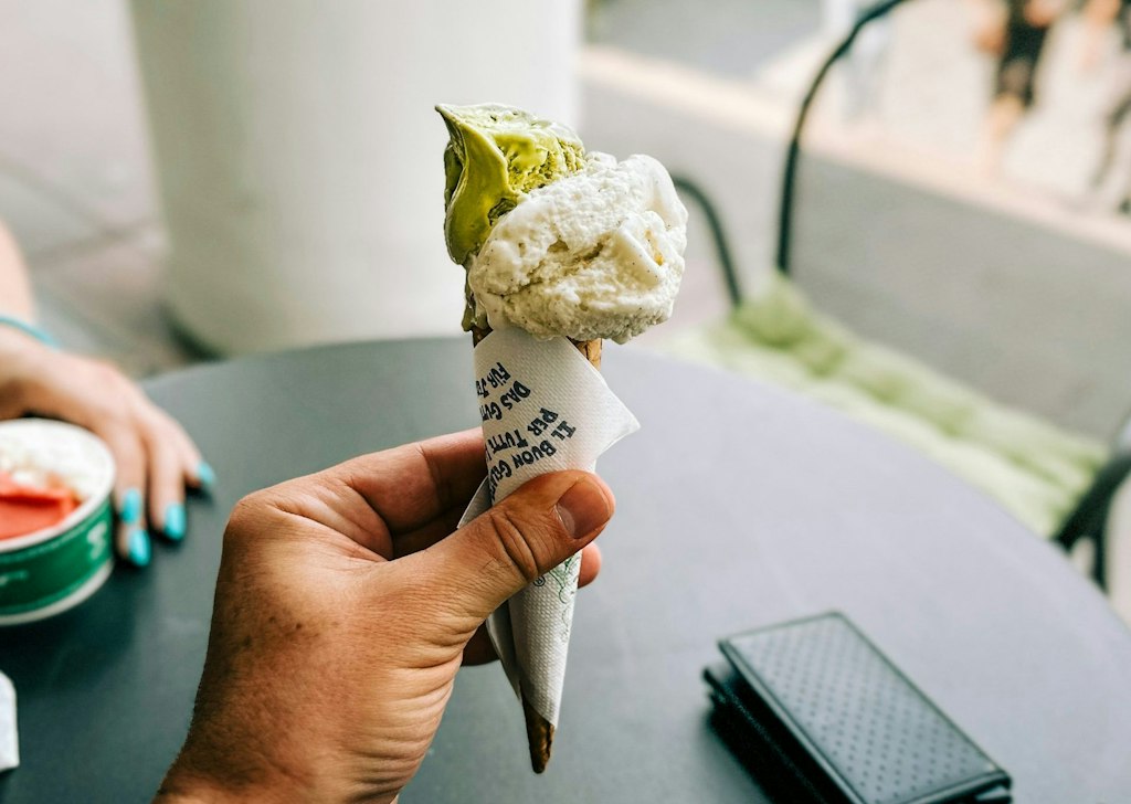 Photo by <a href="https://unsplash.com/@tvieso?utm_content=creditCopyText&utm_medium=referral&utm_source=unsplash">Travis</a> on <a href="https://unsplash.com/photos/a-person-is-holding-up-an-ice-cream-cone-okaiu4dX7dU?utm_content=creditCopyText&utm_medium=referral&utm_source=unsplash">Unsplash</a> Italy gelato