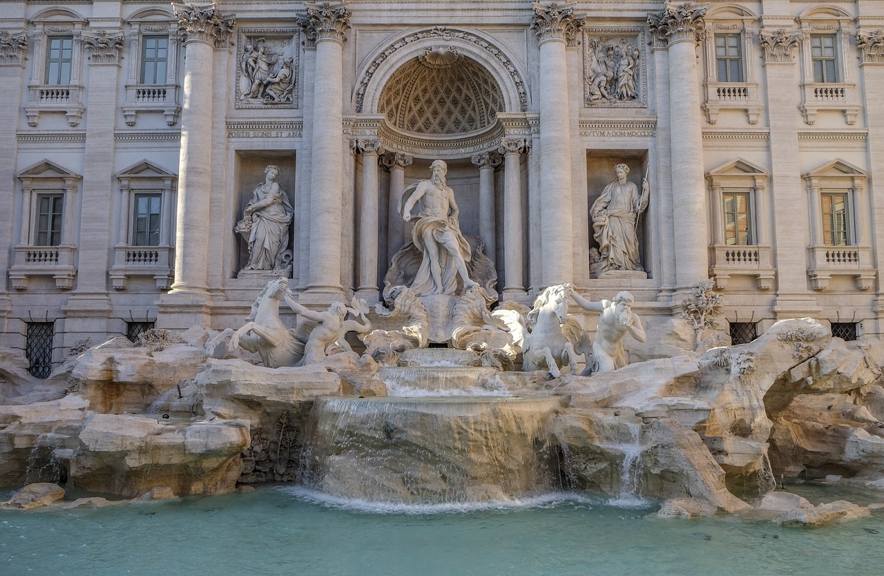 Carved statues rise from the Trevi Fountain's turquoise water in Italy