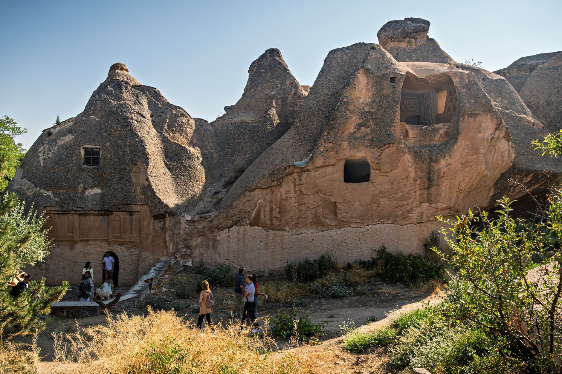 Narrow stone passages and carved chambers inside an underground settlement.