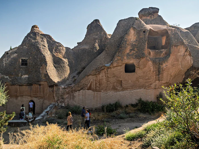 Narrow stone passages and carved chambers inside an underground settlement.