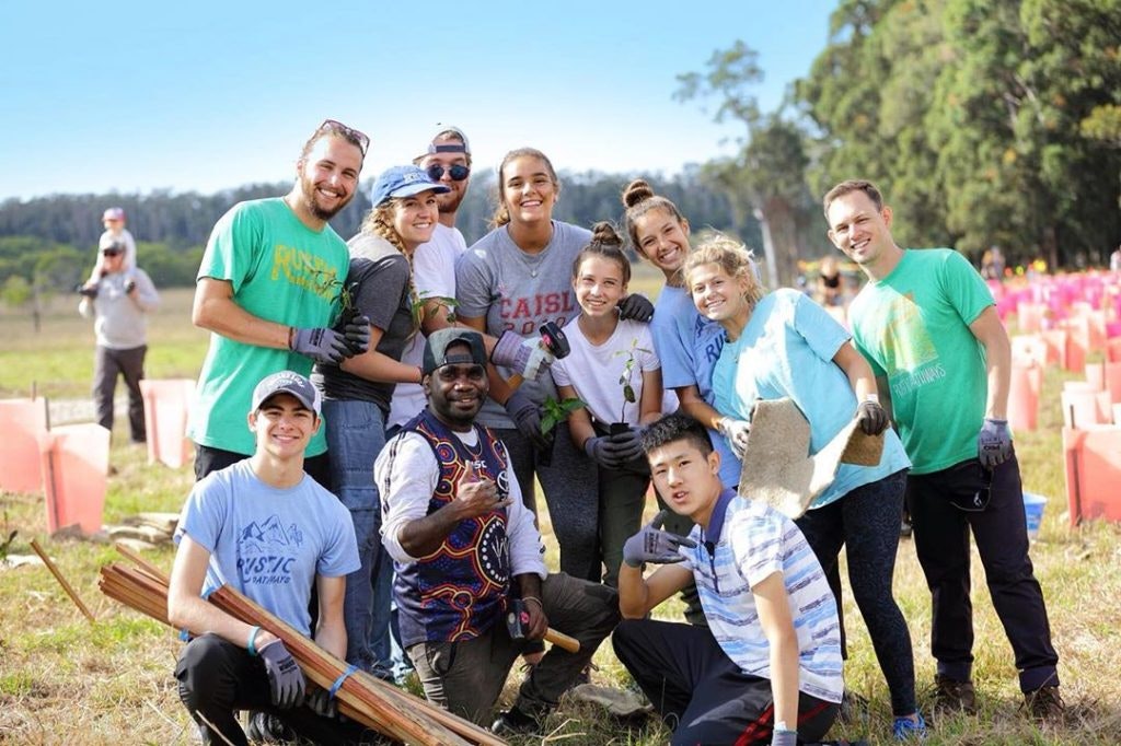 Rustic Pathways teen travelers with their supervising program leaders taking a break during a community service project abroad.